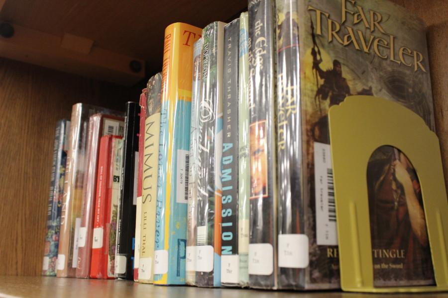 Library books are placed on shelves for the 2013-2014 school year. 