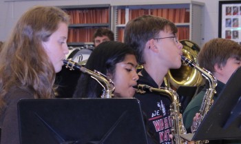 The saxophone players execute their notes to complete the song. 
