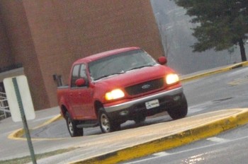 Red Ford truck dropping off a student at school on a wintery morning. Photo by: Tyler Ritz