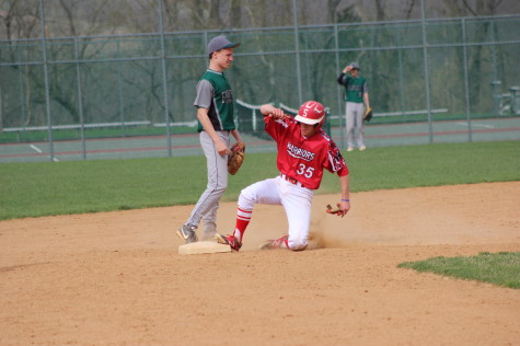 Sophomore Connor Hood slides into second after stealing a base during the 2014 season. He hopes to continue stealing bases during his junior year.  Photo by: Bethany Miller
