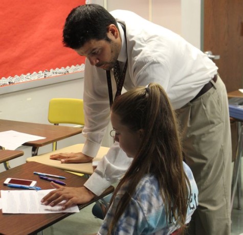 Cousineau helps a student with an assignment. Photo by Karly Matthews. 