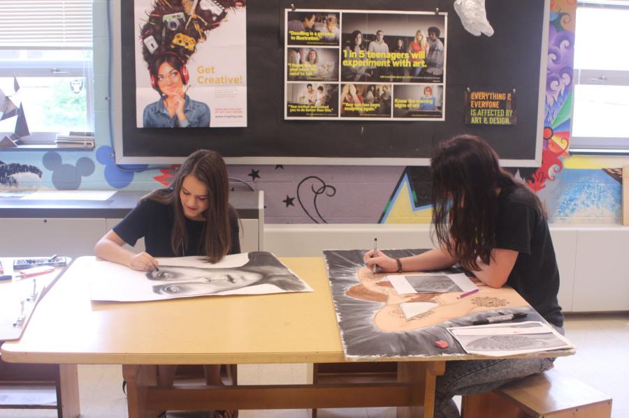 Seniors Casey Torbert and Mollie Larum have found their niche in Mr. Myers art classes. Photo by: Abigail Bentz