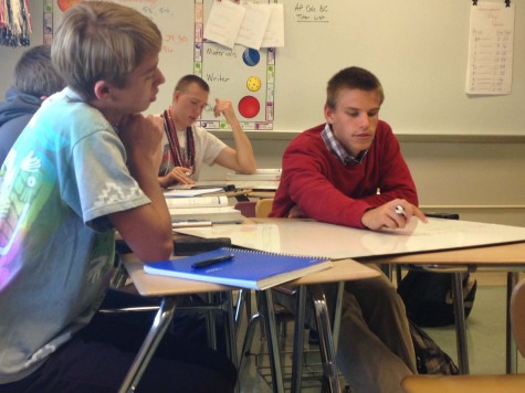 Junior Gibson Porter and senior Zach Orner work on whiteboard problems in AP Calculus AB.