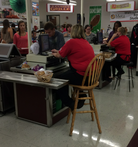 Students purchase lunch in the high school cafeteria. 