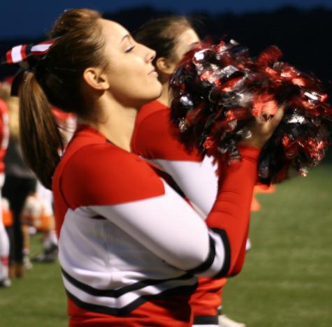 Junior Abbi Mahan cheers on the football team against the Trojans of York Suburban. Photo by Kerrie DeFelice.  