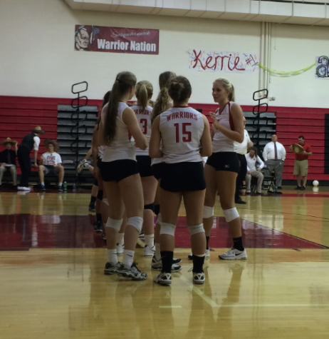 Seniors of the volleyball team stand together pre game. Photo by Luke Bond.