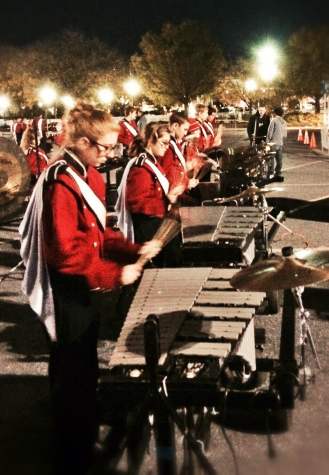 Members of the pit (a group of the band that doesn't march) warm up before the show. Photo by John Smith.