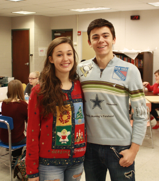 Junior Laura Savin and sophomore Vance Zoeltsch sport their respective sweaters.