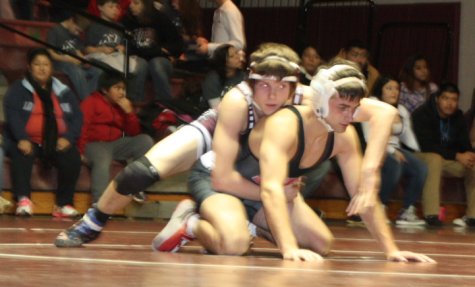 Senior Conor Hinkle (bottom), prepares to take down his opponent. Photo by Mike the reporter