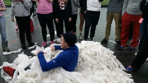 Junior Dan Stifler sits in one of the two piles of toilet paper that was piled up after the toilet paper war.