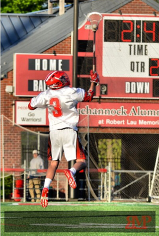 Senior Josh Attig jumps in the air to retrieve the ball in a game from last season. Courtesy of Red Metz Photography.