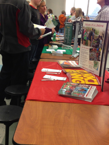 Fliers and brochures were offered to students and parents browsing the institutions.  Photo By: Grace Burns