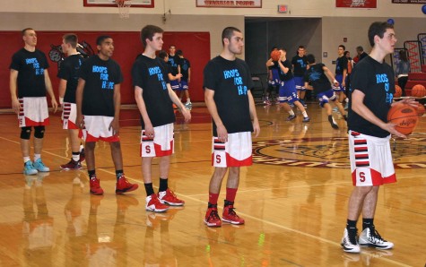 The boys basketball team reps their Hoops for Hope shirts in their game that raises money for the Gastric Cancer Foundation. Courtesy of yearbook.