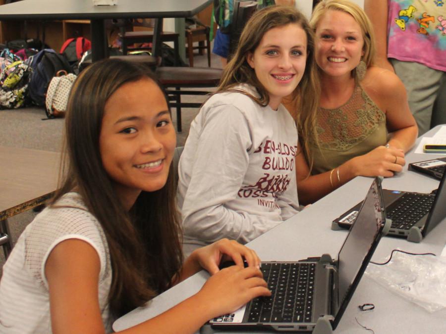 Jessica McDonald, Kayla Held, and Kate LeBlanc test their new Chromebooks.