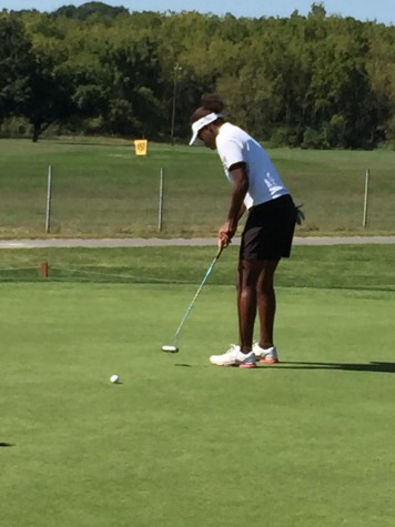 Sophomore Kendel Abrams works on the practice green. Photo by Ray Lingenfelter.