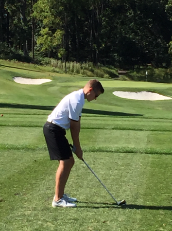 Sophomore Brendan Paules lines up for a fairway shot. Photo by Ray Lingenfelter.