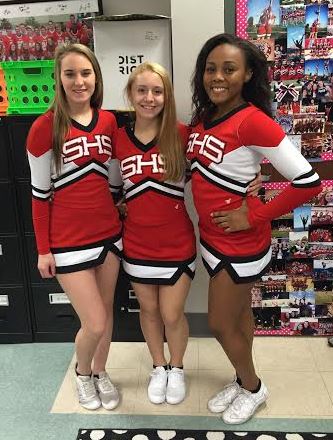 Senior cheerleaders Hailee Vaught, Lexi Manker and Nia Bennett dressed in uniform for the pep rally. Photo by Karly Matthews.
