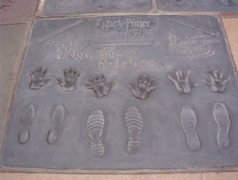 Harry Potter actors Emma Watson, Daniel Radcliffe, and Rupert Grint immortalize their handprints at Grauman's Chinese Theater.