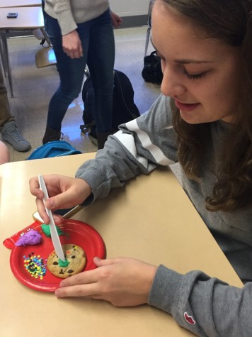 Senior Robyn Chandler decorates a cookie in the spirit of the holiday. Photo By: Karly Matthews