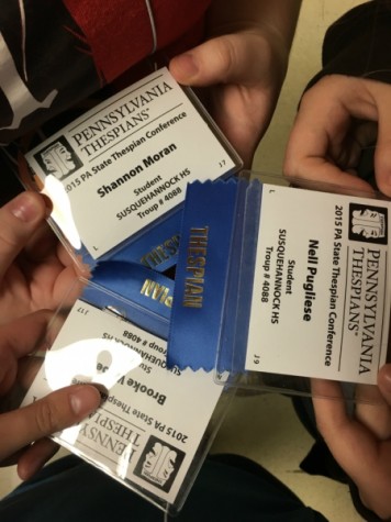Troupe members Shannon Moran, Nell Pugliese, and Brooke Weber proudly display their name tags at the festival.
