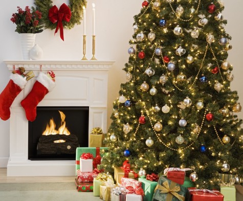 A decorated Christmas tree and stockings, which are typical decorations in homes of those who celebrate Christmas.