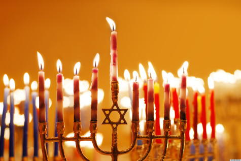 A Menorah with it's candle lit. One candle is lit for each night of Hanukkah.
