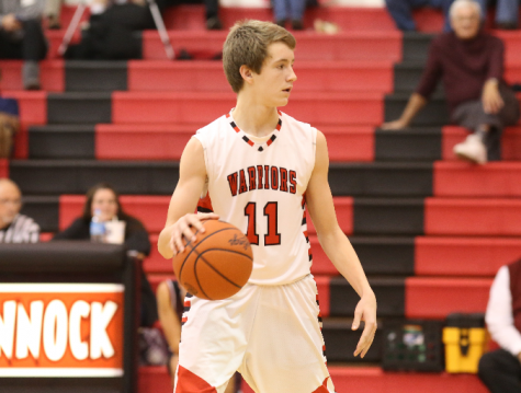 Junior guard Adam Hedgeland looks to pass during a game. Photo by Mike Inkrote.