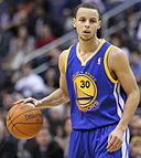 Stephen Curry brings the ball up the court. By Keith Allison from Owings Mills, USA (Stephen Curry) [CC BY-SA 2.0 (http://creativecommons.org/licenses/by-sa/2.0)], via Wikimedia Commons