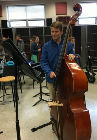 Freshman Greyson Daviau plays his bass in orchestra, a class he says he would recommend to anyone.