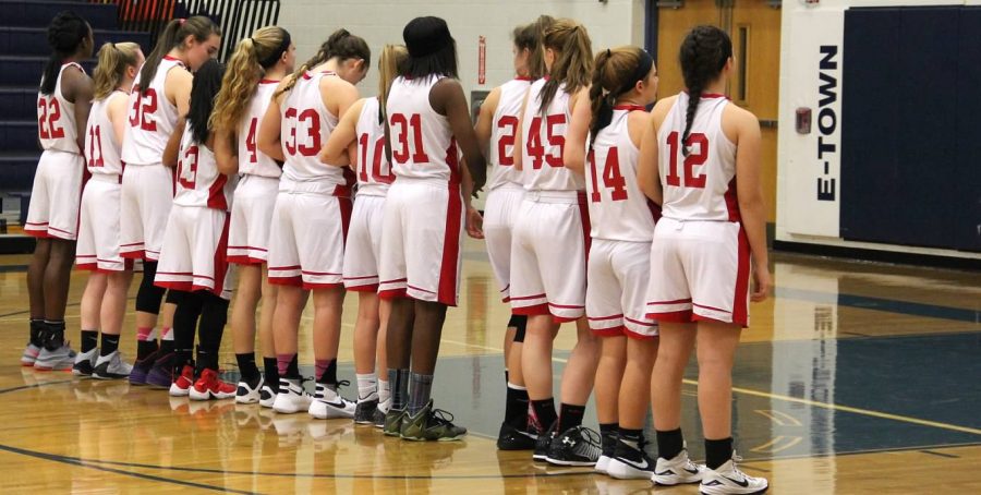 Girls basketball lines up for the national anthem.