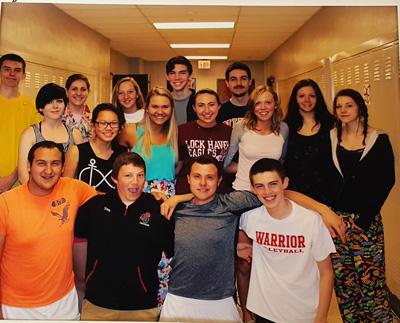 Elise Delozier stands with a smile on the far right side of this 2013-2014 staff picture. 