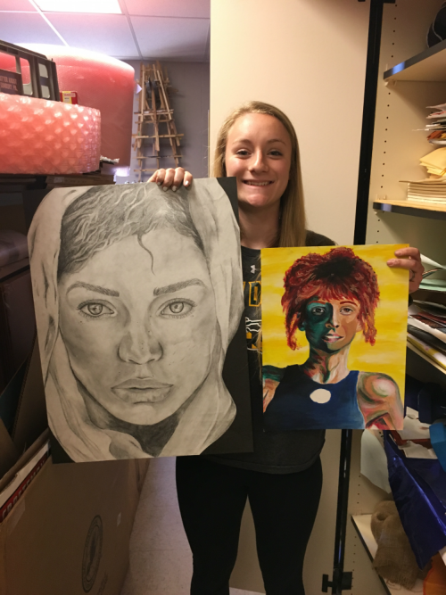 Senior and Artist of the Month Rachel Miller proudly displays two of her more recent pieces.