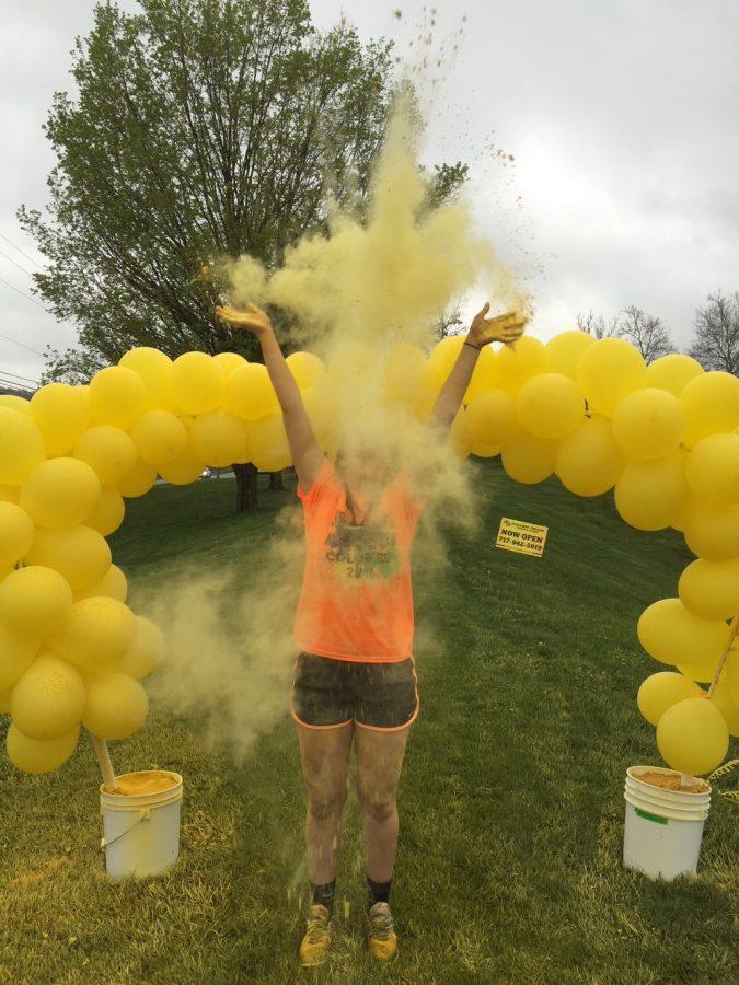 Junior Kelsey McCullough throws powder into the air. Photo courtesy Kelsey McCullough.