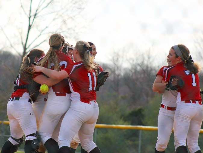 Some members of the girls softball team celebrate after their rivalry win against Dallastown. Photo by Lori Staub.