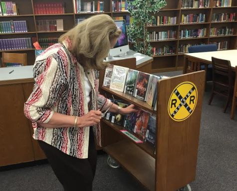 May helps librarian Kayse Corrieri get the school library ready for summer. Photo by the author.