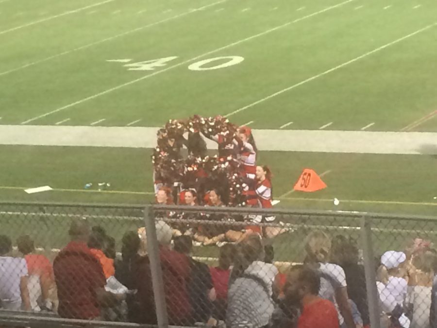 The cheerleaders spell out an S to support the football team. 