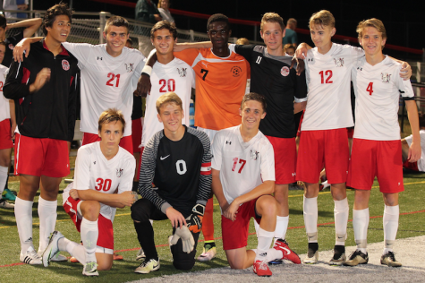 Susquehannock varsity players reunite with former Warrior soccer player Cheikh Cisse. Photo courtesy of Laurie Kettinger. 