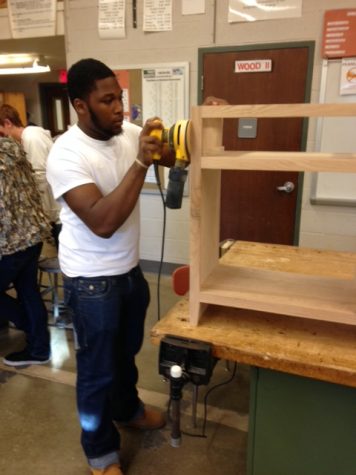 Senior Jamon Brown helping construct the new ticket booth.