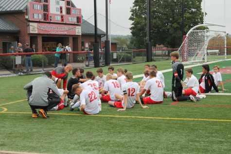 The varsity team in a huddle during halftime.