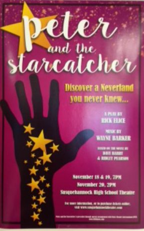 A Peter and the Starcatcher poster hangs in school hallway. 