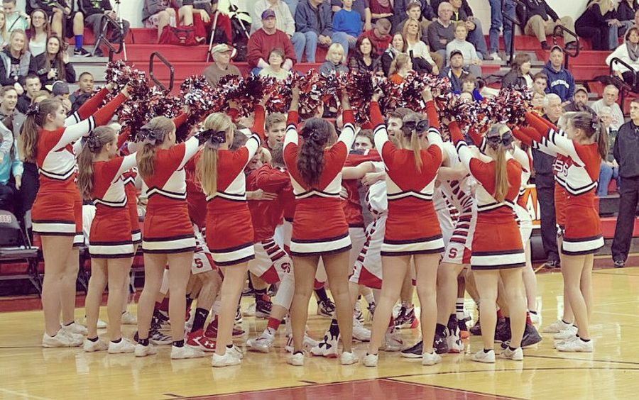 The Basketball team & Cheerleaders join in a chant before players take to the court. Photo courtesy of Jackson Murphy.