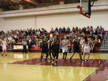 The Lady Warriors battle with Dover for rebounds under the basket.