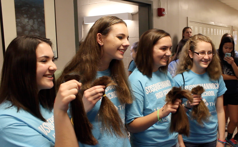 Mini-THON participants show off their new haircuts after donating hair for cancer patients. Photo by Dan McNair.