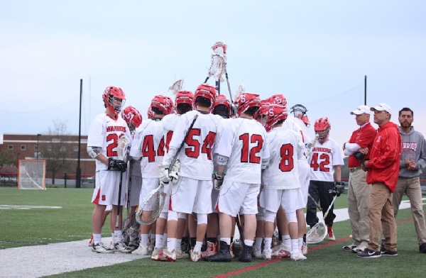 Boys lacrosse gets pumped before a game.