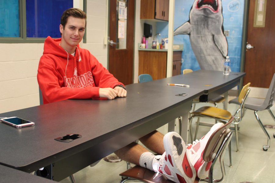 Senior Grant Barnhart waits for his marketing class to start. Photo by Christopher Norris