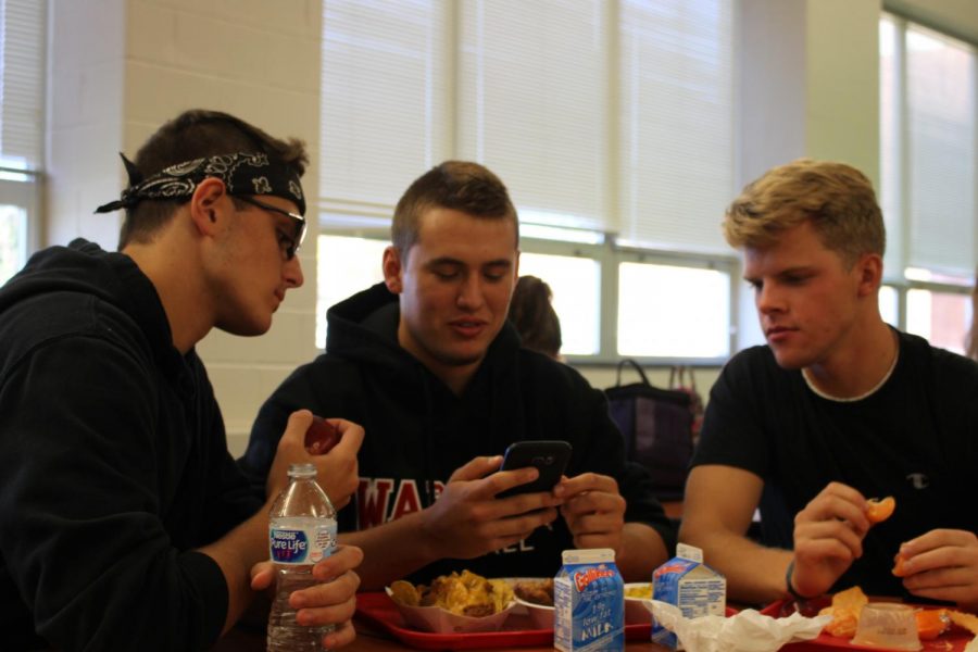 [From left to right] Seniors Ethan Schammel, Alec Kramer, and Same Odegaard socialize at lunch. Photo by Chris Norris