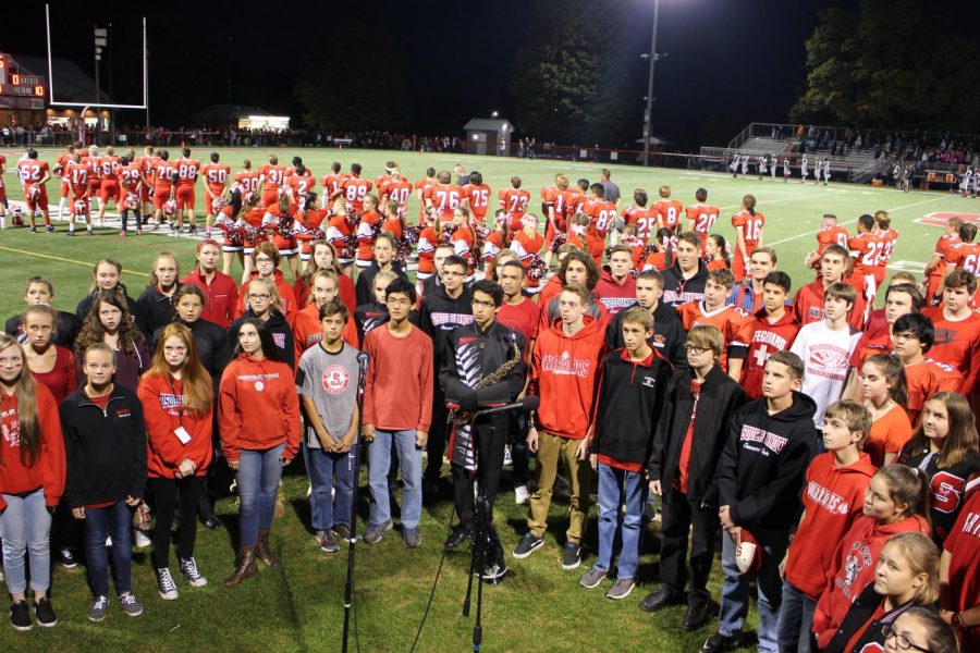 Susquehannock concert choir sings the National Anthem prior to kickoff.
