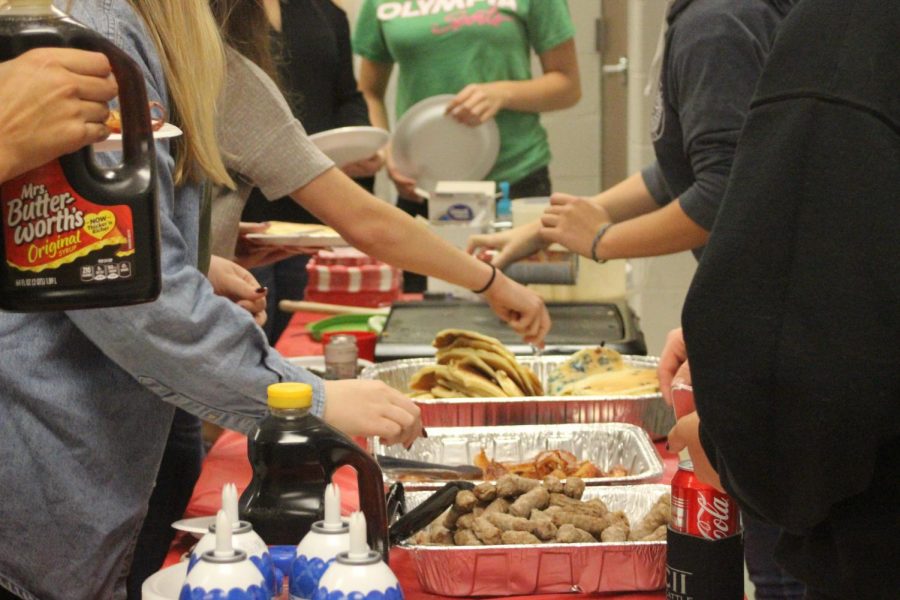 Student council grabs a plate of breakfast prepared by fellow leaders. 
Photo by Brittany Boone
