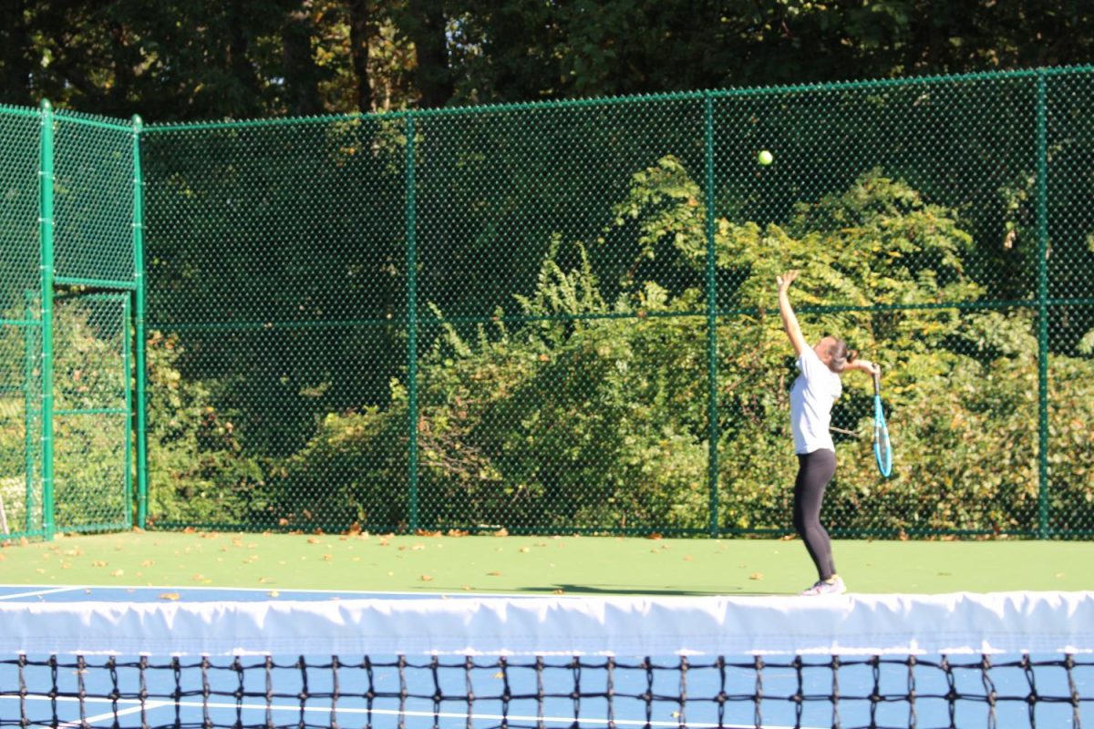 Freshman Kaitlyn Endres practices her serve for Counties. Photo by: Jade Reall 