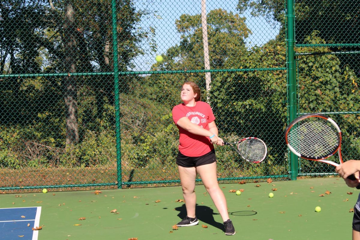 Senior Molly Hogan prepares to hit the tennis ball. Photo by: Jade Reall 